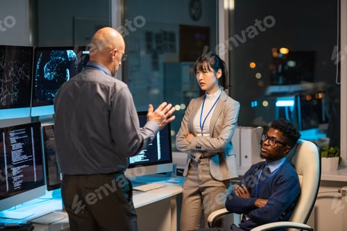 Preview: Mature manager giving instructions to intercultural subordinates