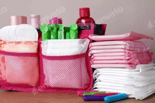 Preview: Different menstrual pads, tampons and skin care products on wooden table, closeup