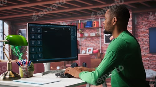 Preview: Black male freelancer at home uses AI chatbot for task completion