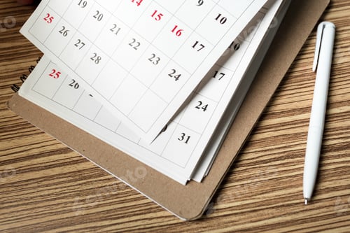 Preview: Planning weekly tasks with an organized calendar and a pen on a wooden table