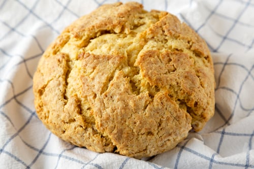 Preview: Homemade Irish Soda Bread on cloth, side view. Close-up.