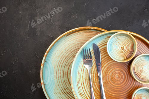 Preview: top view brown plates with fork and knife on dark background table glass meal kitchen color cutlery