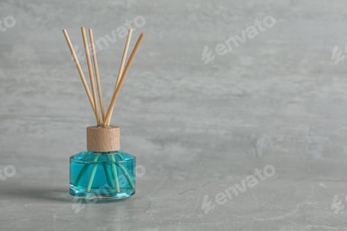 Preview: Aromatic reed freshener on grey table, space for text