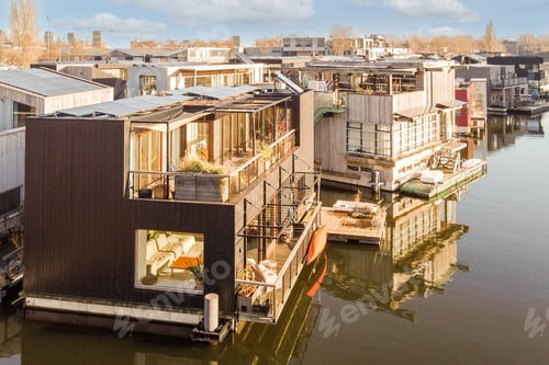 Aperçu: a row of floating homes on a body of water