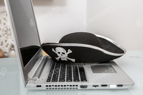Preview: Creative Representation of Hacking and Online Scams With Pirate Hat on Laptop