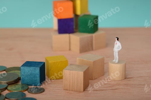 Preview: The ambitious businessman, perched on a wooden block