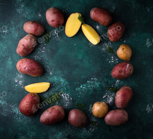 Preview: Raw uncooked potato on green table
