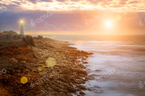 Preview: Beautiful nightly seascape with lighthouse and moody sky at the sunset