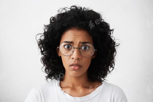 Preview: Human emotions, feelings, reaction and attitude. Startled mixed race girl wearing big round glasses