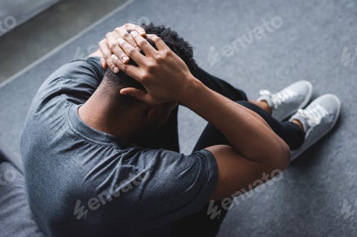 Preview: depressed african american man having panic attack at home