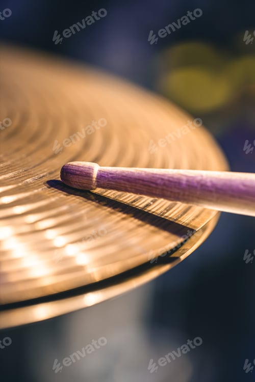 Preview: Close-up of drumsticks on a cymbal drum.