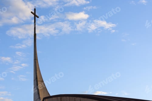 Preview: Low angle shot of cross on a church against a cloudy sky