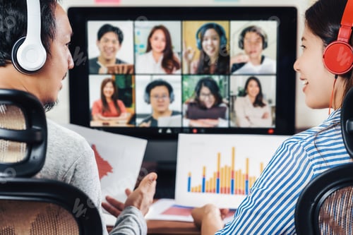 Preview: Rear view of Asian partner working and online meeting via video conference with colleague
