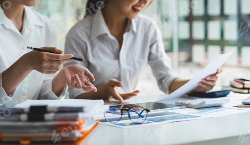 Preview: Businessmen holding pens and graph paper are meeting to plan sales to analyze investment results and