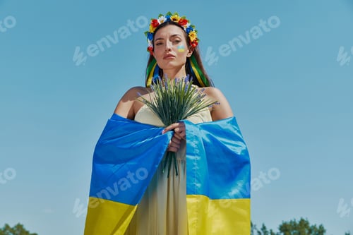 Preview: Beautiful Ukrainian woman covering with national flag
