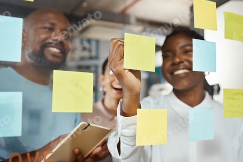 Preview: Shot of a group of businesspeople brainstorming with sticky notes on a glass screen