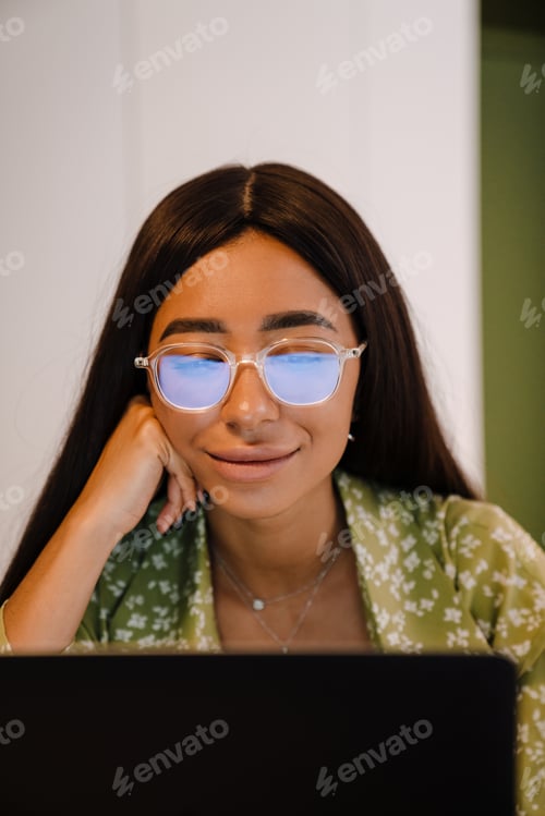 Preview: Portrait of young beautiful woman in glasses and green blouse
