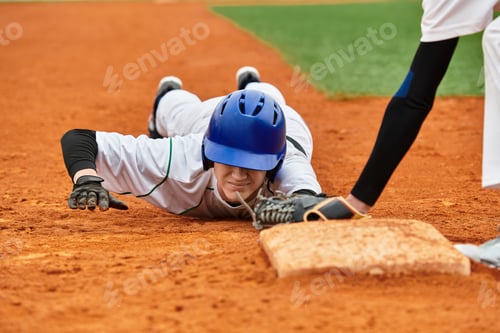 Preview: Teenage boys enjoying a competitive baseball match on a sunny field