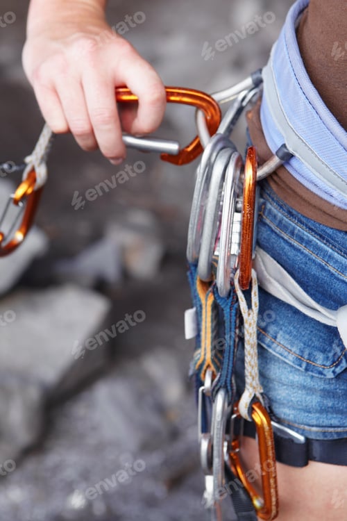 Preview: Attaching herself to the rope. A rock climbers hook with an assortment of clips attached to it.