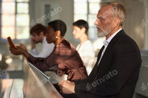 Preview: Senior Man Sitting at Church and Listening to Sunday Sermon