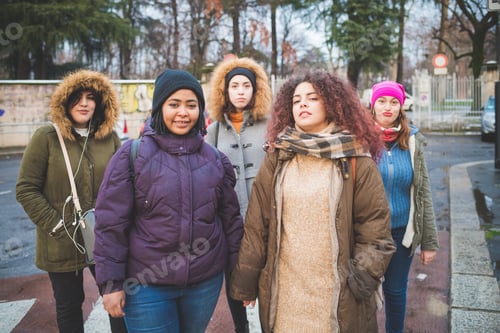 Preview: group of young women posing for picture in the street