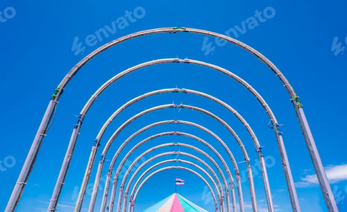 Preview: Steel tunnel playground equipment structure with carousel tent against blue clear sky background