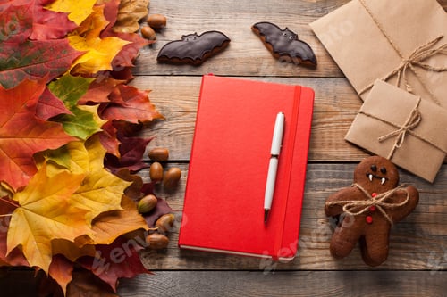Preview: Red notebook with pen and paper envelopes on old wooden table.