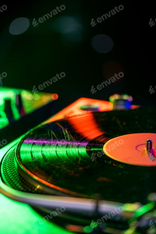 Preview: sound mixer and vinyl in nightclub with back light