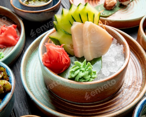 Preview: side view of marinated herring fillets with sliced cucumbers ginger