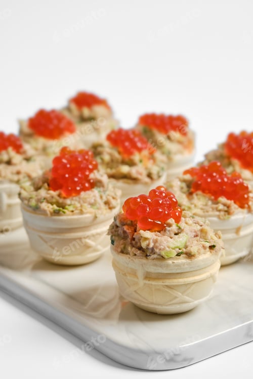 Preview: Tuna tartlets with red caviar served on a white platter for a stylish appetizer display