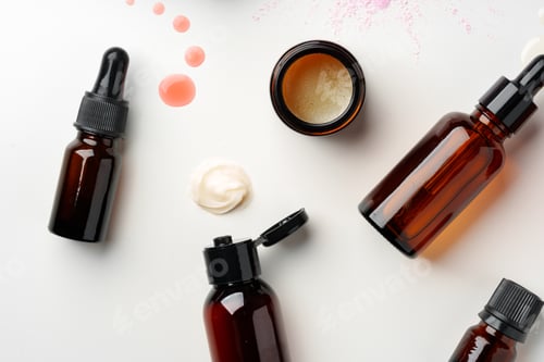 Preview: Assorted Skincare Products and Powder Spilled on a White Background