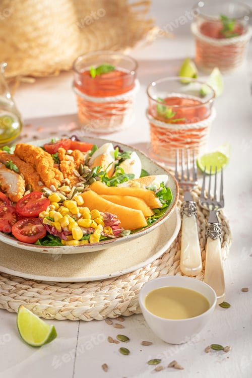 Preview: Healthy salad with chicken, salad, melon and eggs.