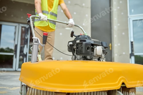 Preview: Workman applying a road sweeper on the construction site