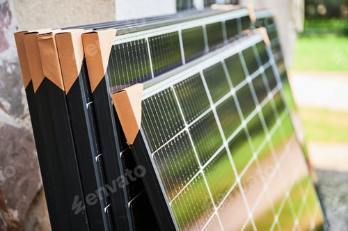 Preview: Close-up new solar panels with protective cardboard corners ready for installation.