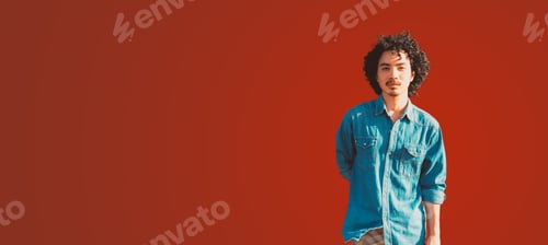 Preview: Young man in denim shirt, red wall