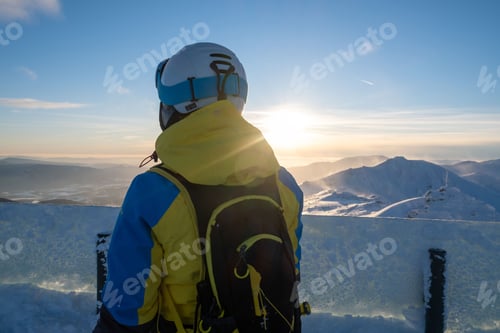 Preview: woman skier looking at sunset above slovakia mountains