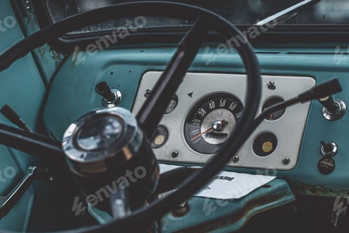 Preview: Closeup shot of a black steering wheel inside of a blue car