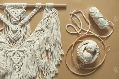 Preview: Macrame. Handmade macrame weaving and cotton threads on a rustic wooden stick.