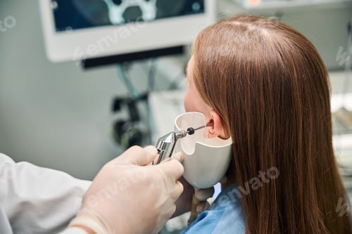 Preview: Close-up of ear examination with medical device