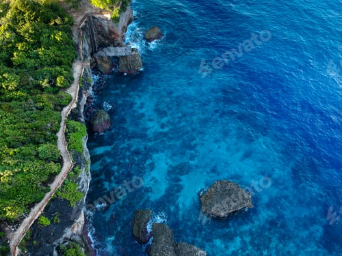 Preview: Rocky cliff with a steep bank on the edge of the cape. Waves crash against the rocky shore.