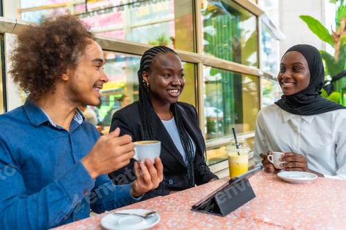 Preview: Diverse friends enjoying coffee and conversation at cafe