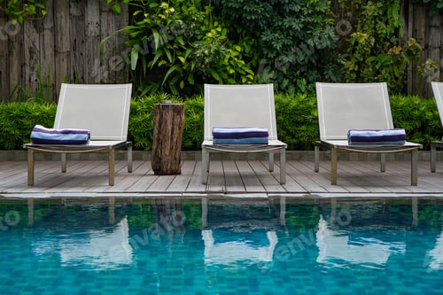 Preview: Deck chair and swimming pool with green vertical garden