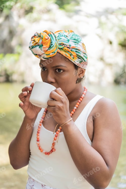 Preview: Young Woman drinking coffee in the forest