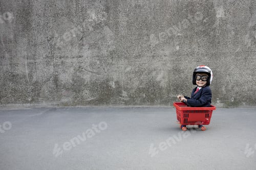 Preview: Funny businessman riding shopping cart outdoor