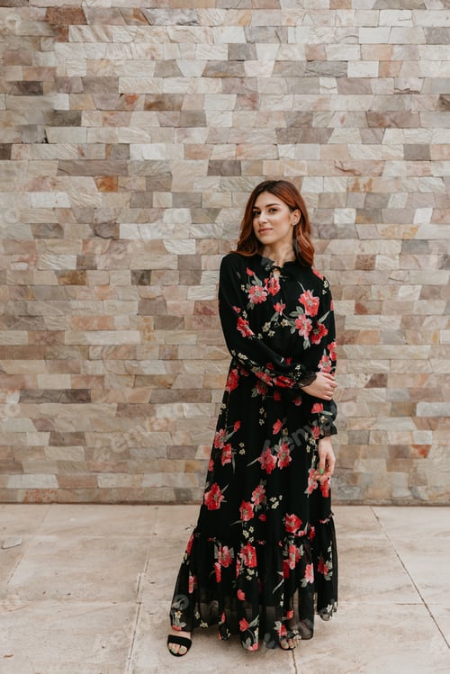 Preview: Beautiful young women in summer dress posing outdoor near red brick wall