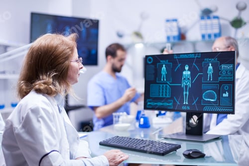 Preview: Female scientist looking at the monitor screen in research room