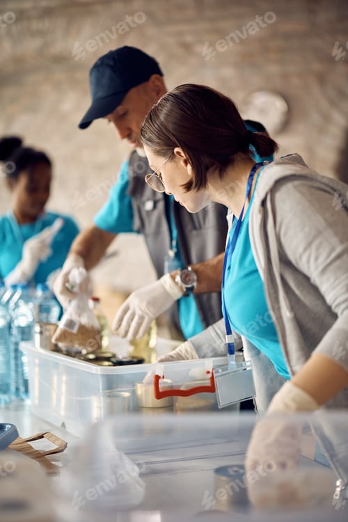 Preview: Food bank volunteers preparing donation boxes for people in need.