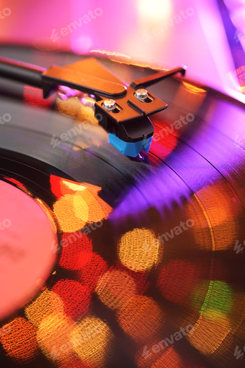 Preview: Vinyl player tonearm with LP record and blured lights.
