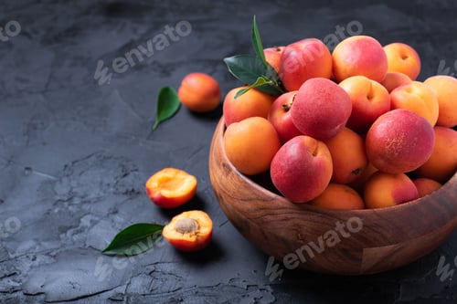 Preview: Ripe apricots on black background. Top view, copy space. Fruit banner. Healthy vegetarian food