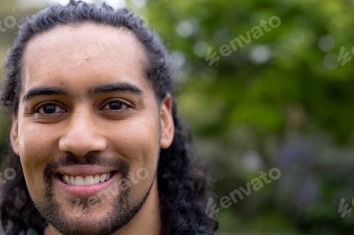 Preview: Smiling young man enjoying nature outdoors, feeling happy and relaxed, copy space